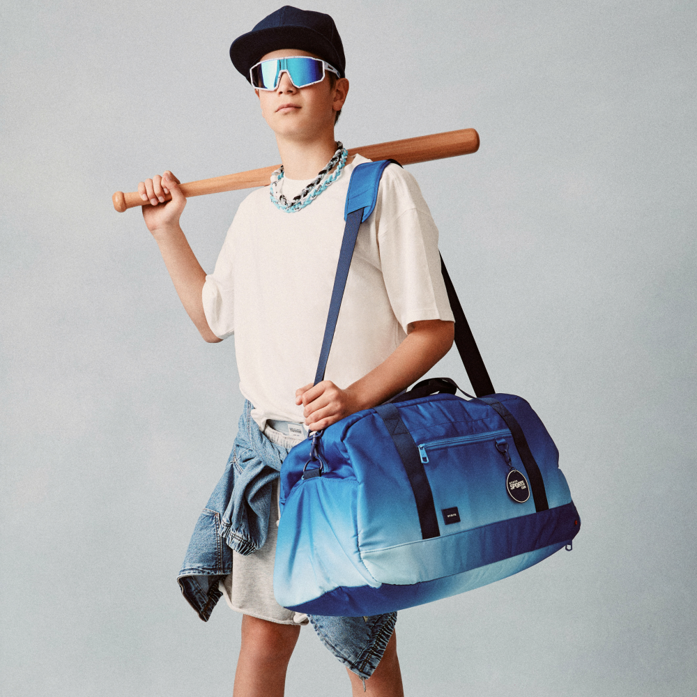 Boy holding STATE Bags Fenway Sports Duffle Blue Gradient