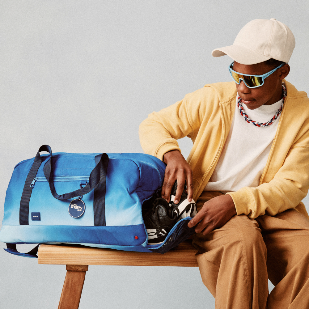 Boy holding STATE Bags Fenway Sports Duffle Blue Gradient