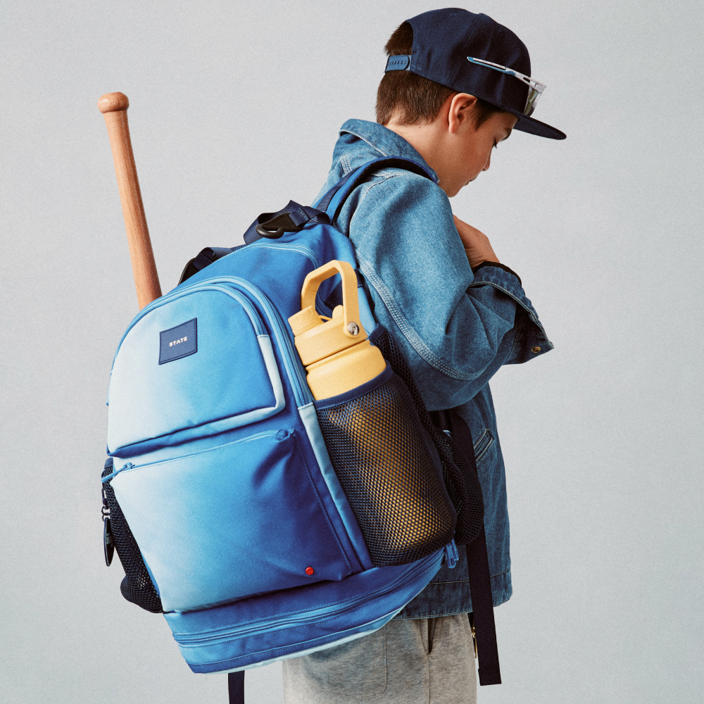 Boy sitting with STATE Bags Shea Backpack Blue Gradient