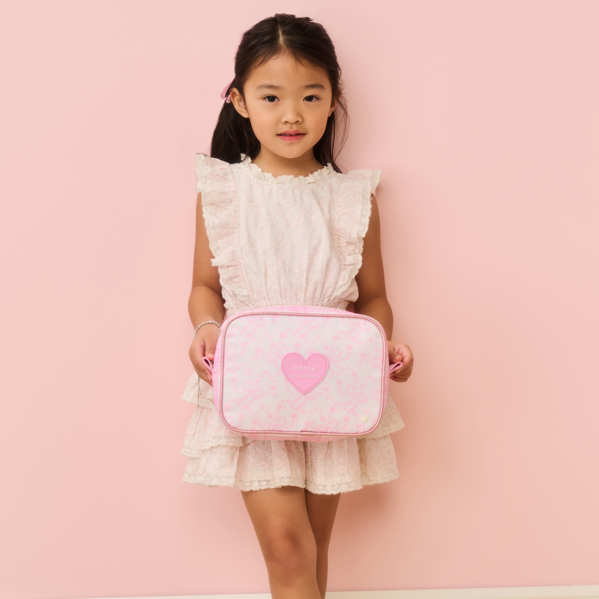 Girl holding STATE x LoveShack Fancy Bags Bensen Toiletry Kit