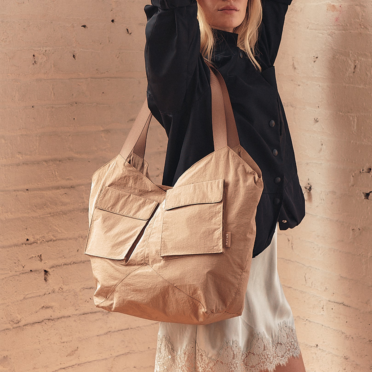 Image showing woman wearing STATE Bags Beverly Tote Crinkled Nylon Affogato 