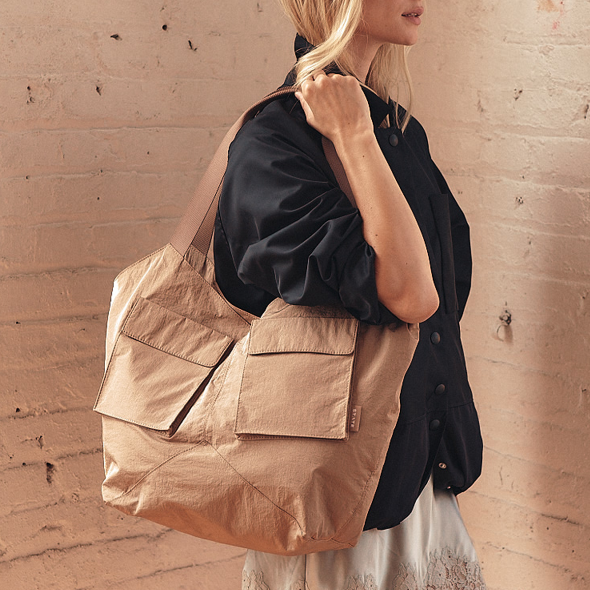 Image showing woman wearing STATE Bags Beverly Tote Crinkled Nylon Affogato 
