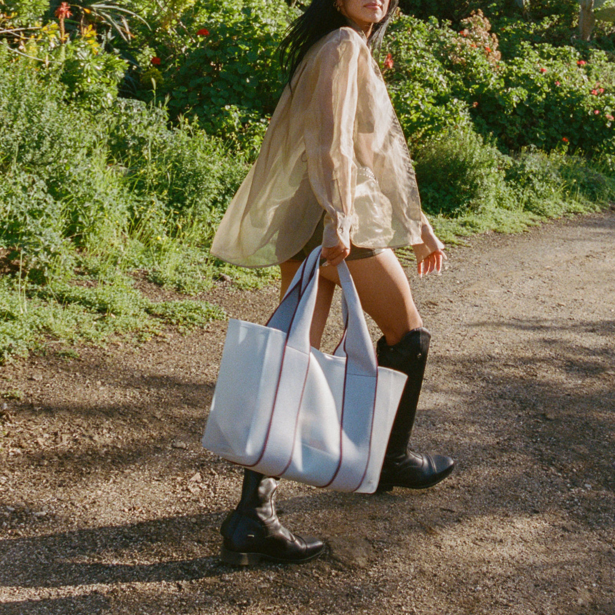 Woman holding STATE Bags Wellington Cabana Tote Blue 
