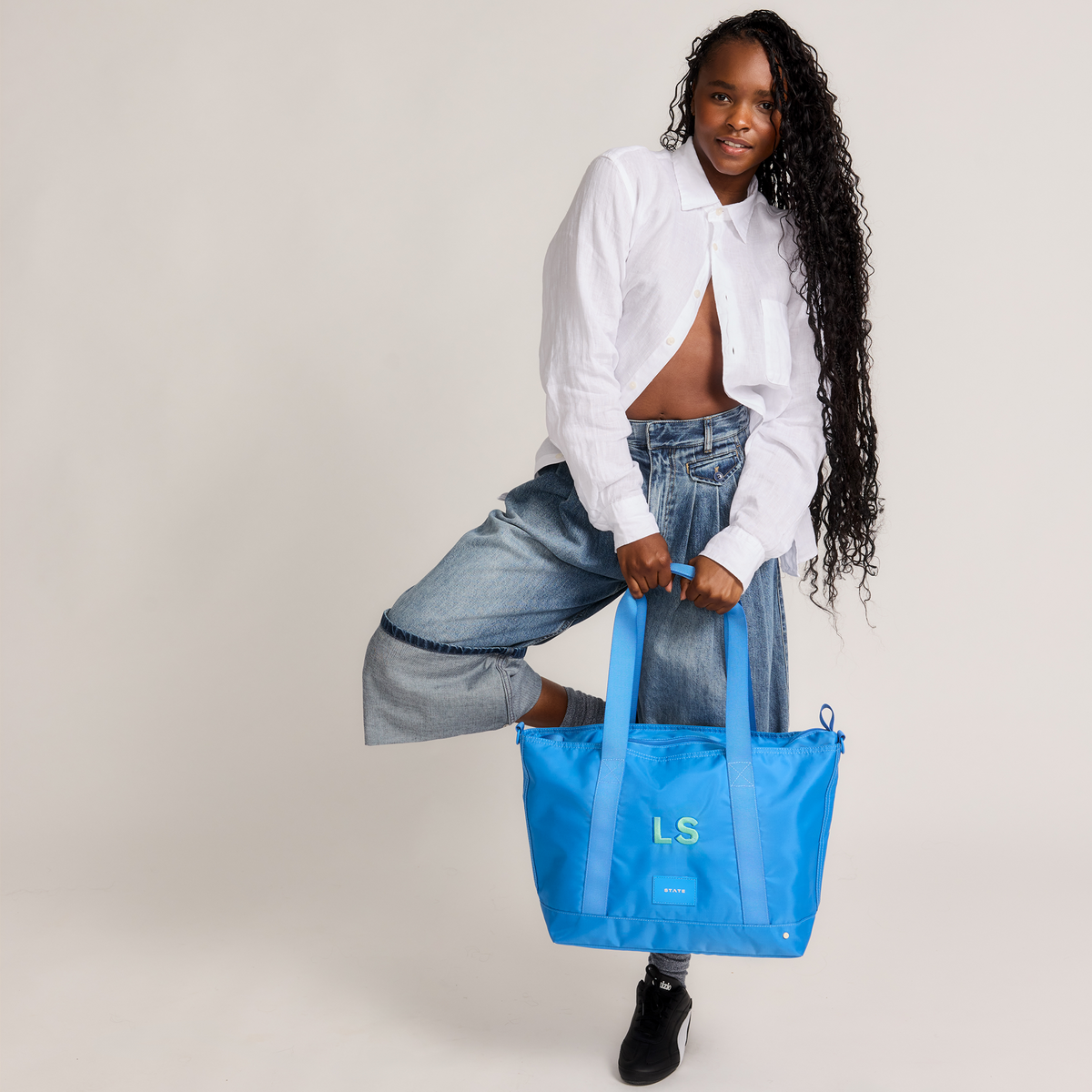 woman holding state bags graham tote blue