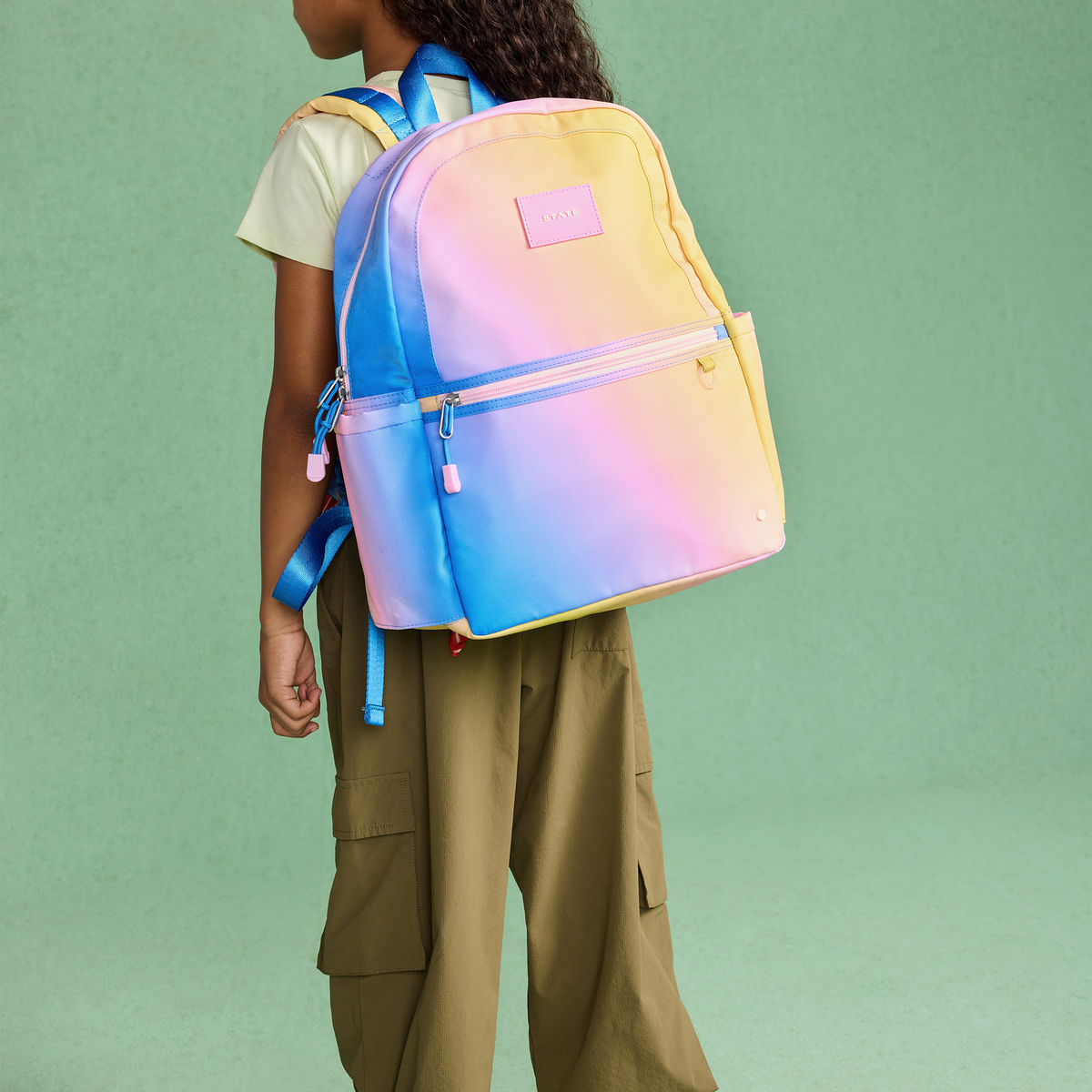 girl wearing girl wearing STATE Bags Kane  Backpack Blue/Pink/Yellow Gradient
