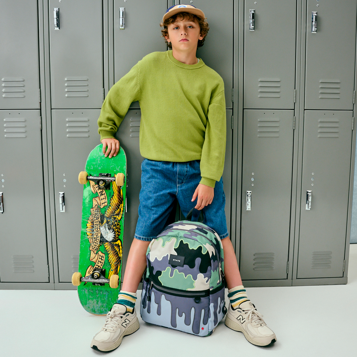 boy holding STATE Bags Kane Double Pocket Backpack Camo Drip 