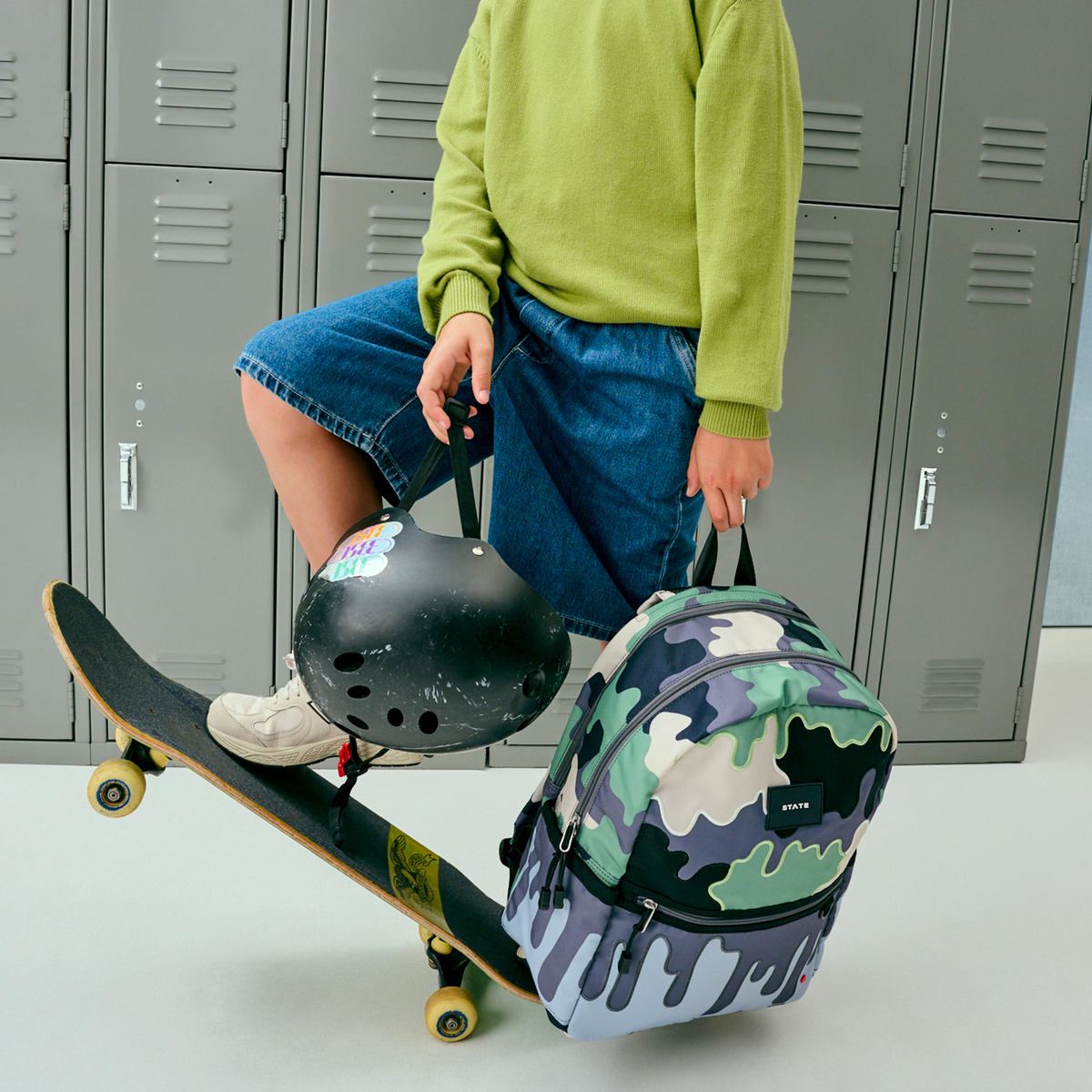 boy holding STATE Bags Kane Double Pocket Backpack Camo Drip 