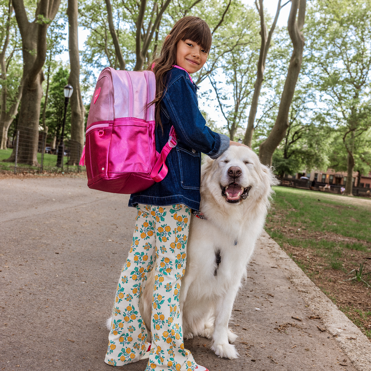 Girl petting a dog wearing STATE Bags Kane Double Pocket Pink/Hot Pink Colorblock