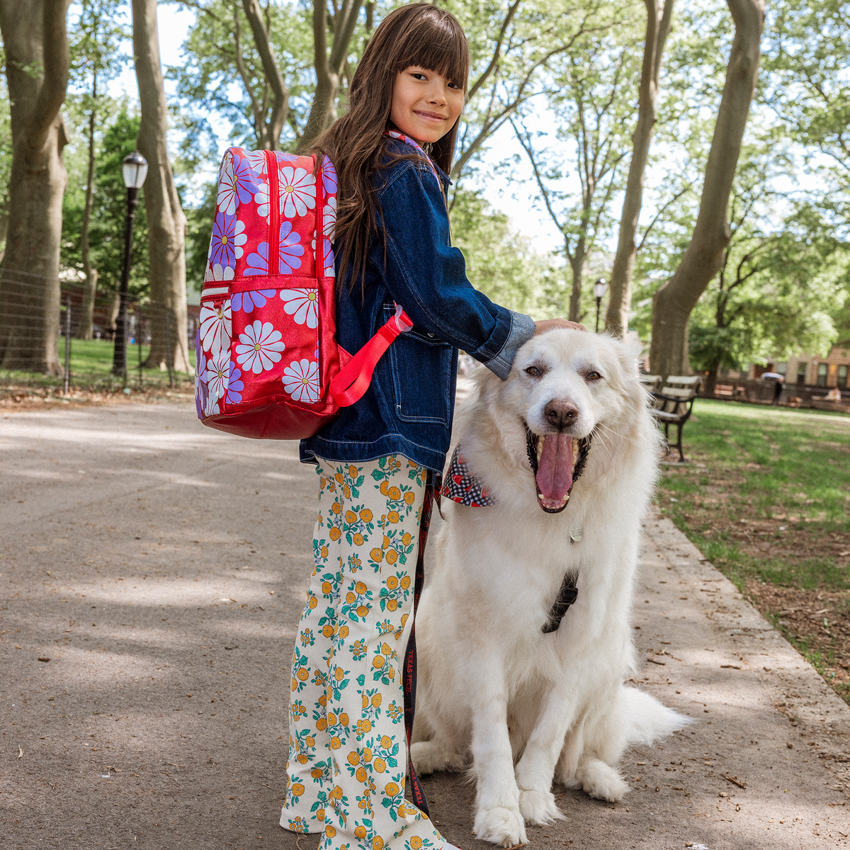 Girl petting dog wearing Kane Double Pocket Ruby Floral 