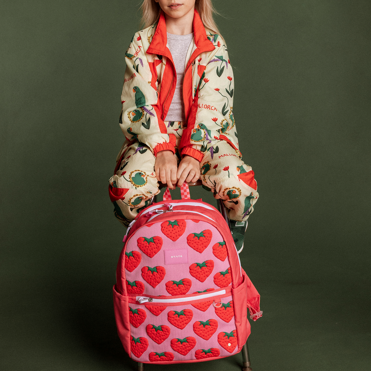 Girl holding Kane Backpack Strawberries