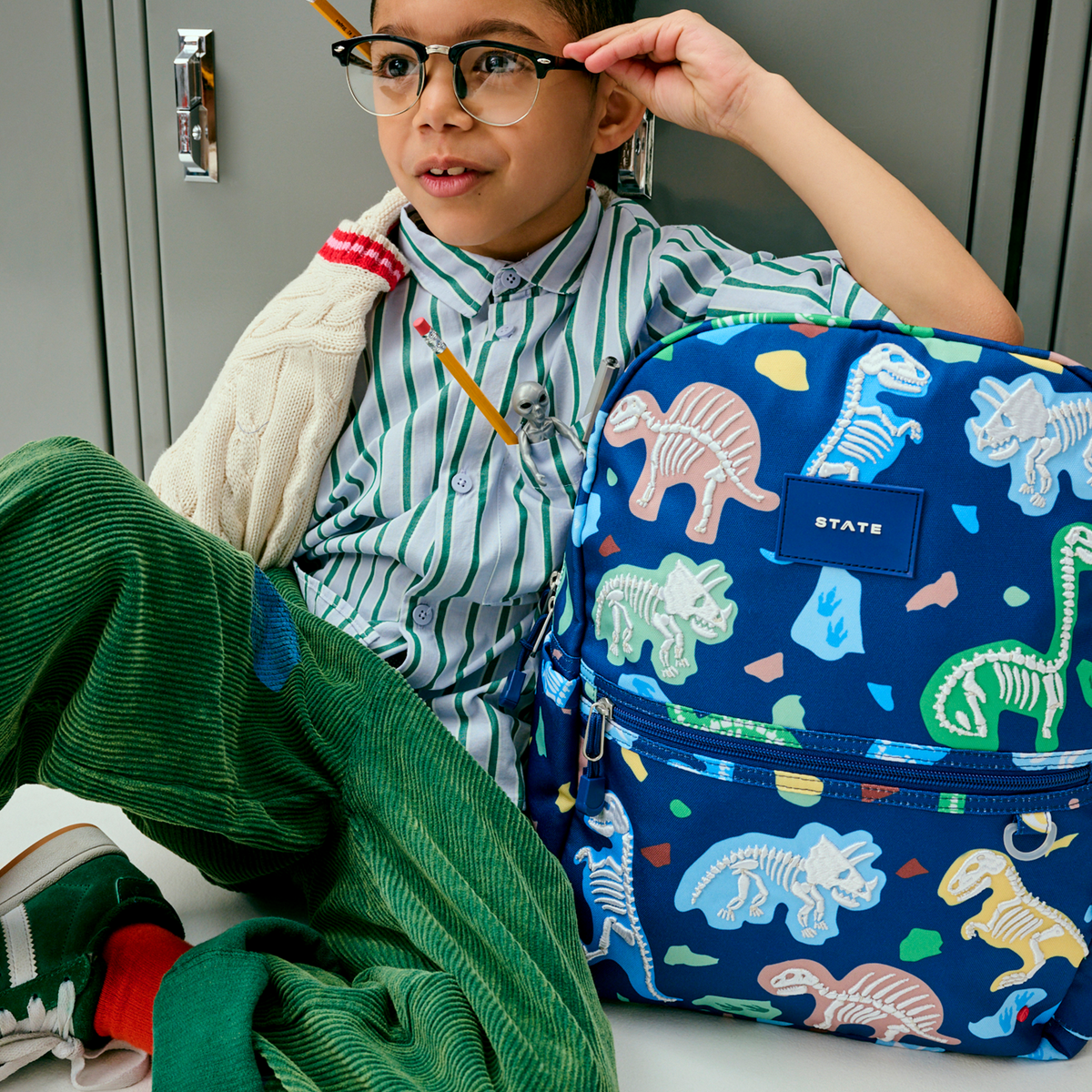 boy with kane backpack dino fossils