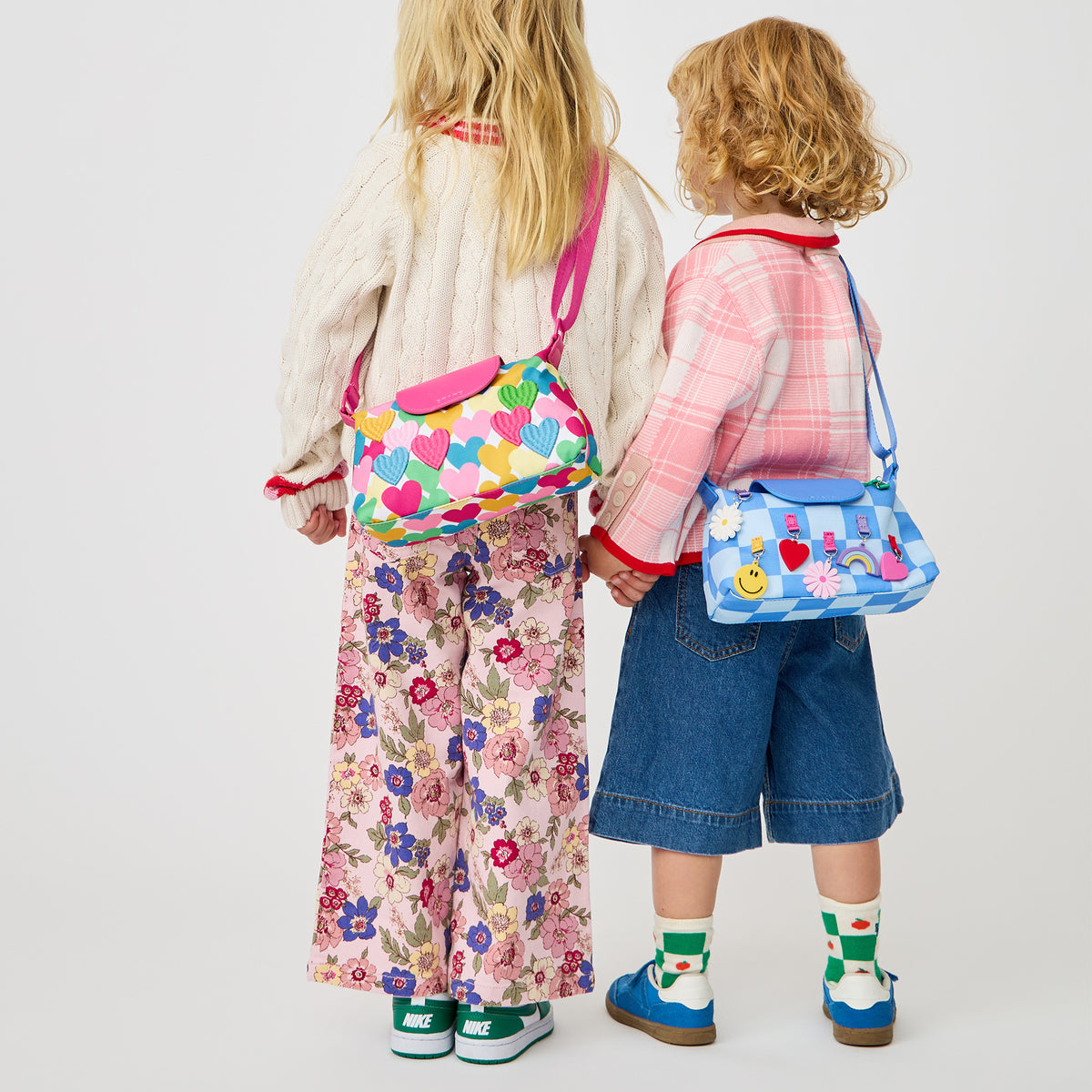 Girl wearing STATE Bags Chelsea Pouchette Happy Fuzzy Hearts 