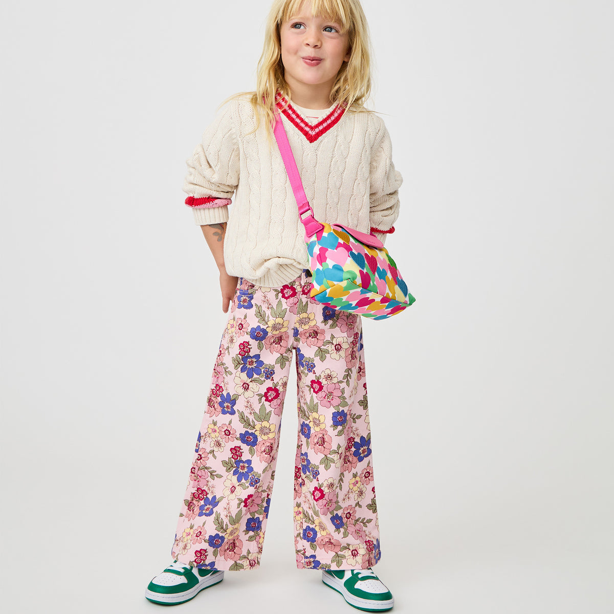Girl wearing STATE Bags Chelsea Pouchette Happy Fuzzy Hearts 