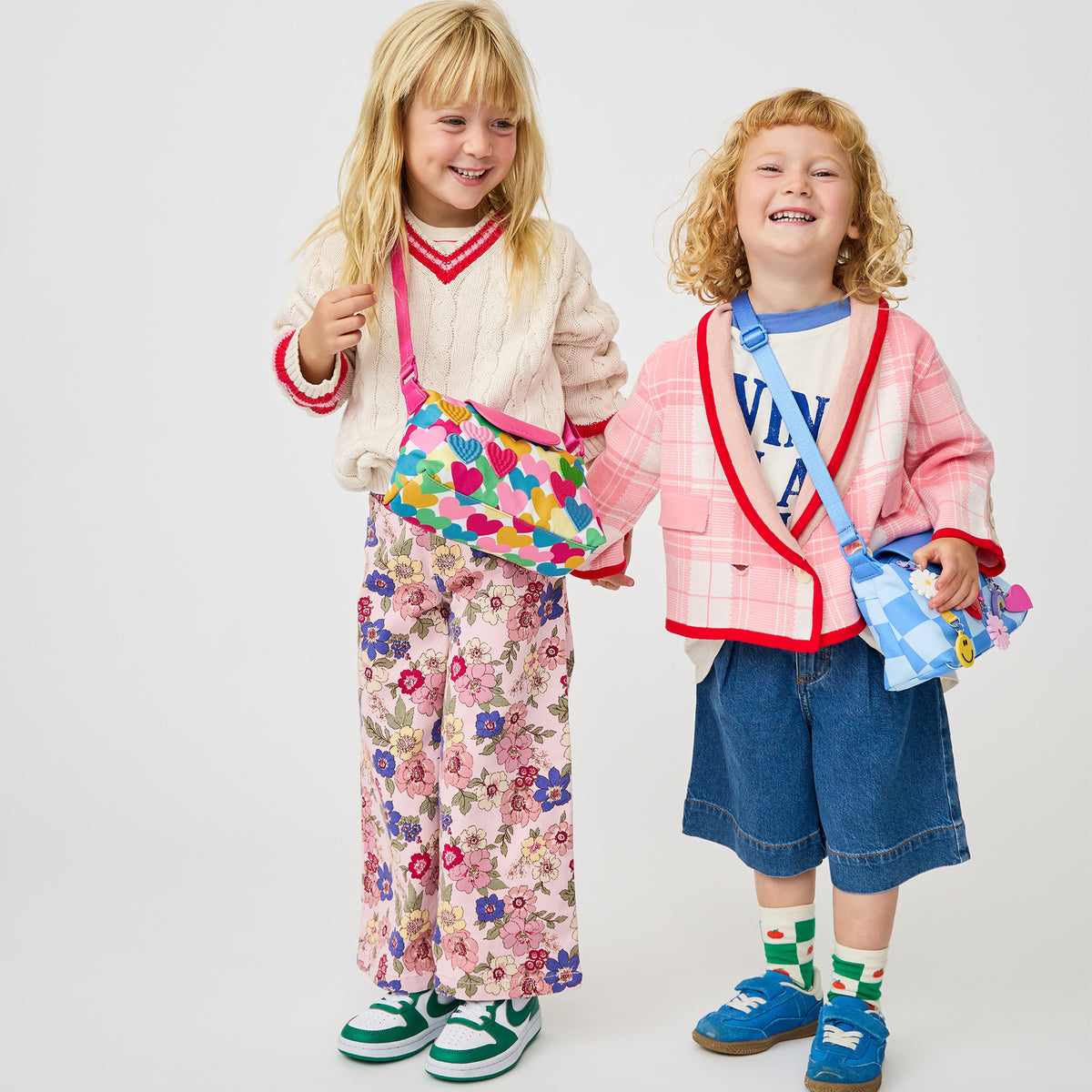 Girl wearing STATE Bags Chelsea Pouchette Happy Fuzzy Hearts 