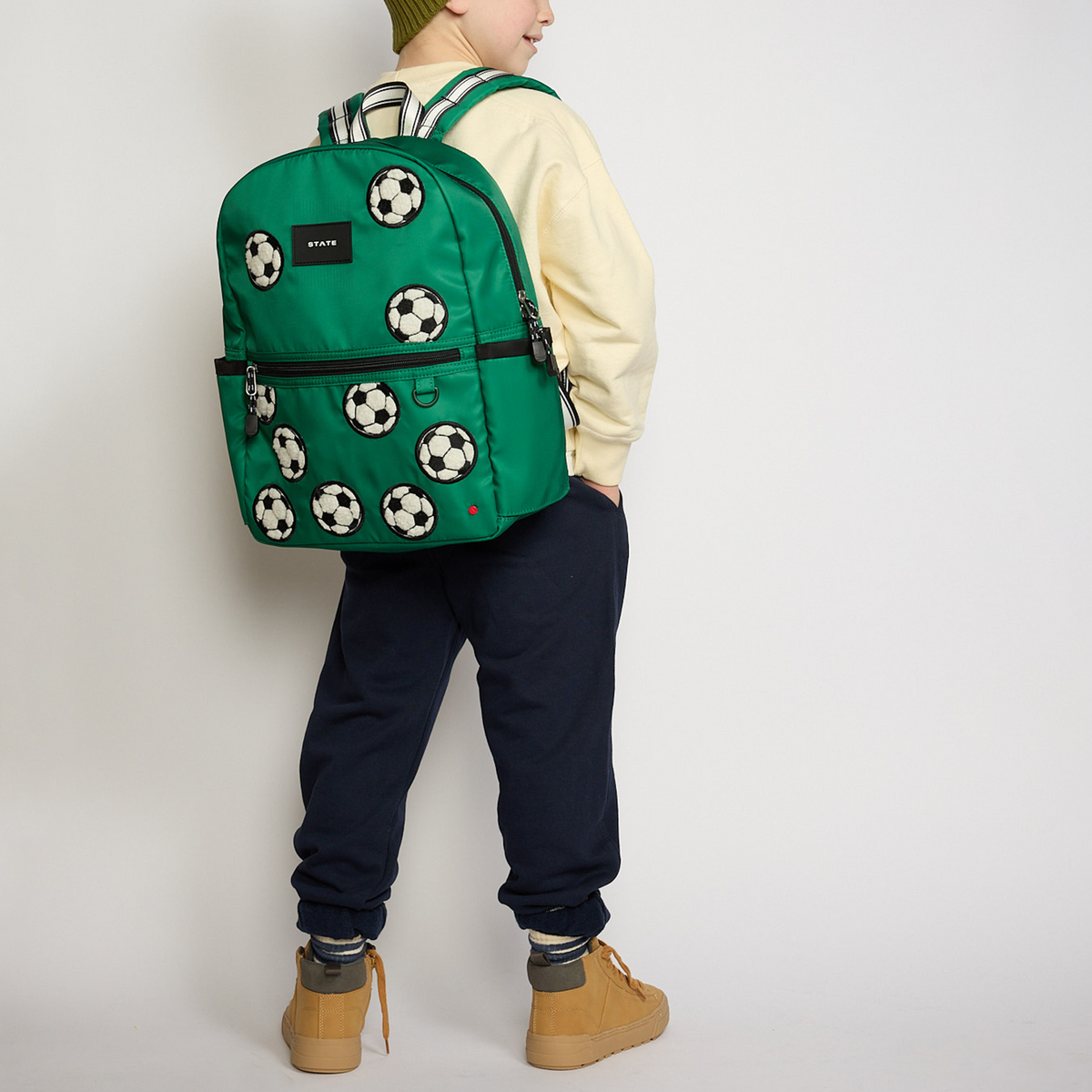 Boy wearing STATE Bags Fuzzy Basketballs