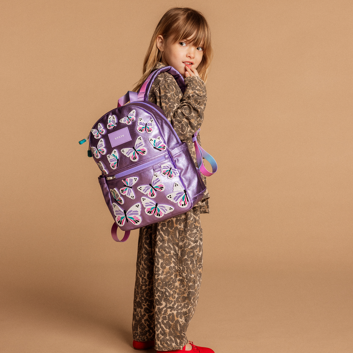 Girl wearing kane mini backpack 3d butterflies