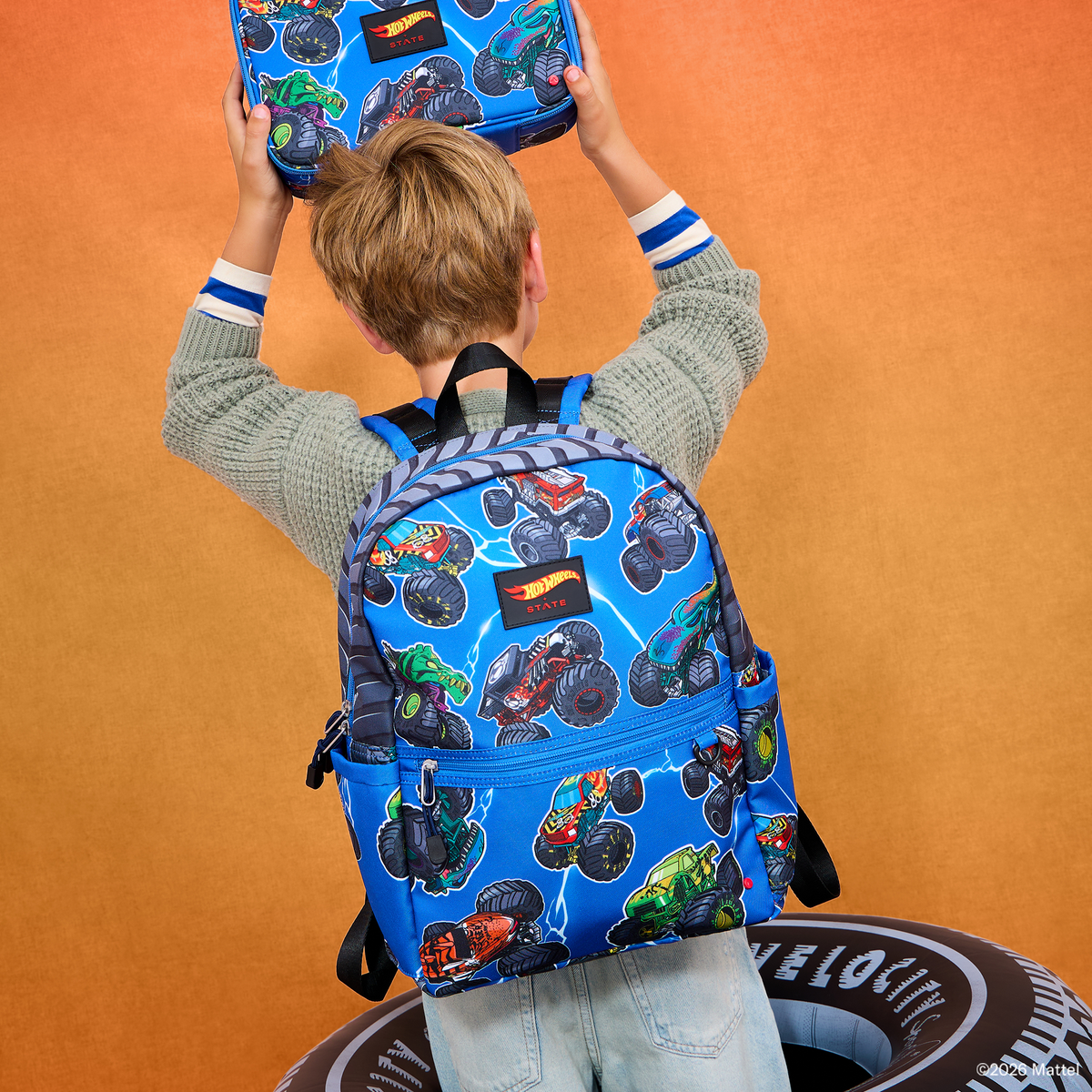 Boy wearing STATE x Hot Wheels™ Kane Backpack Falling Trucks