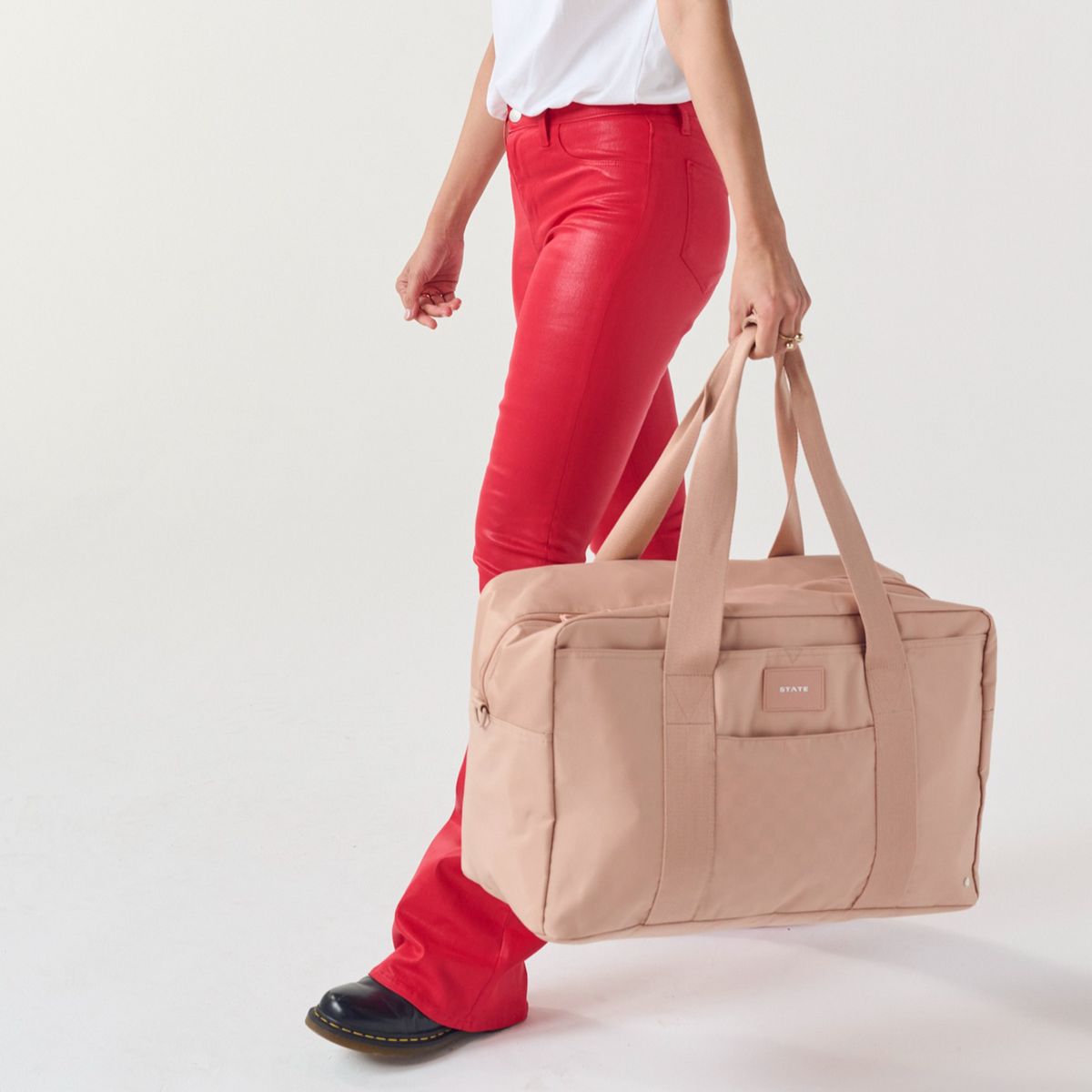 girl holding STATE Bags Wellington Weekender Latte