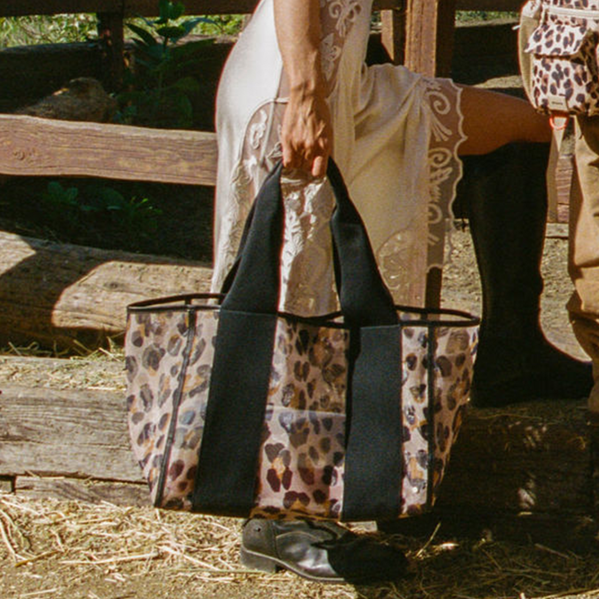 Woman wearing STATE Bags Wellington Cabana Tote Leopard
