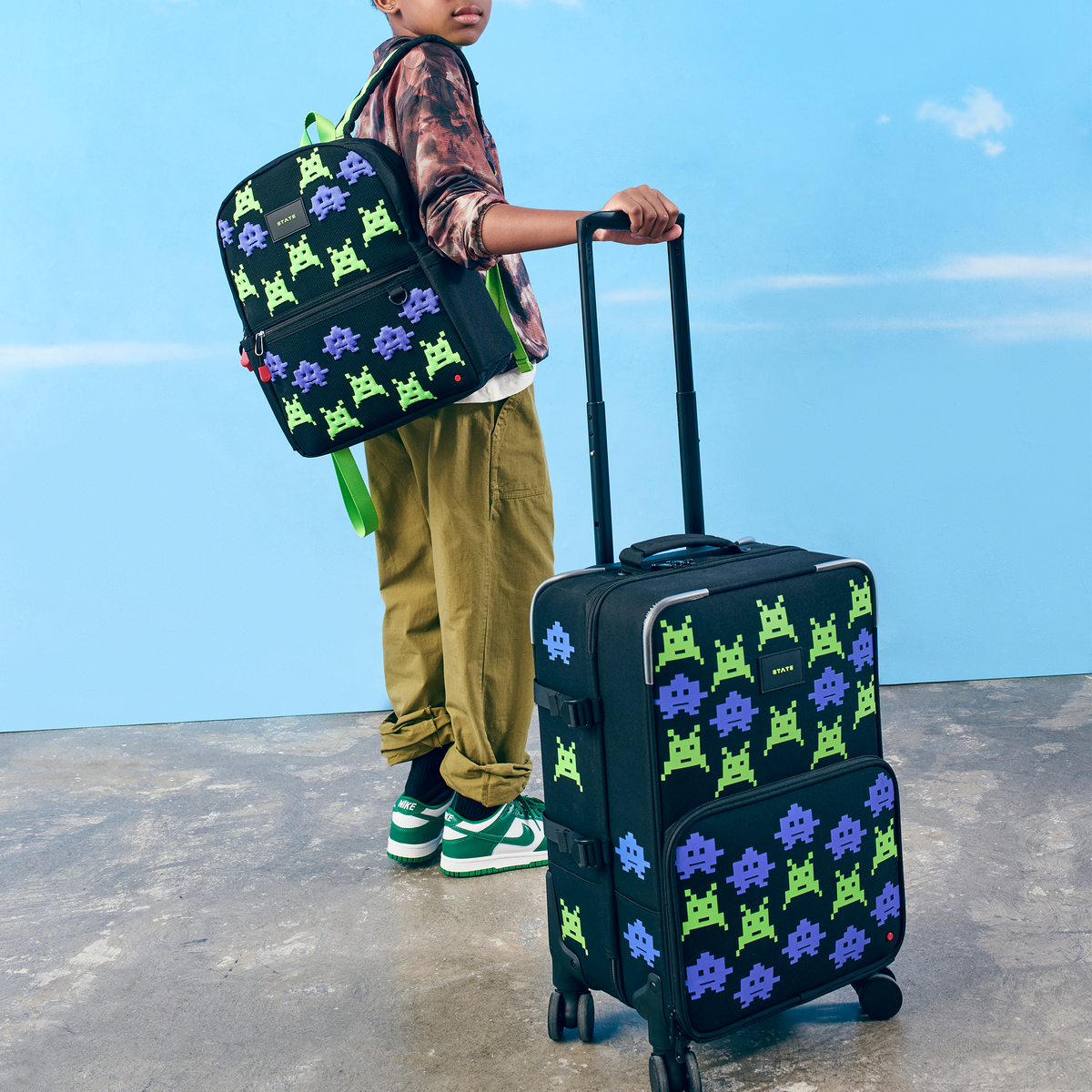 Boy wearing STATE Bags Kane backpack arcade and logan carry-on suitcase arcade