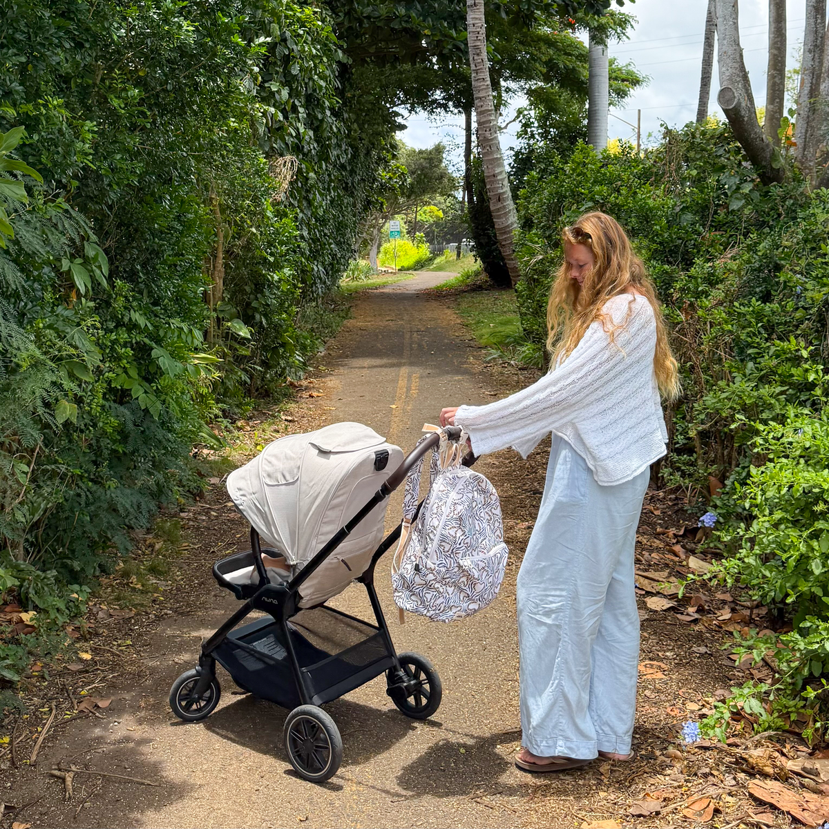 mom pushing stroller with STATE x MagneticMe Lorimer Diaper Bag on stroller