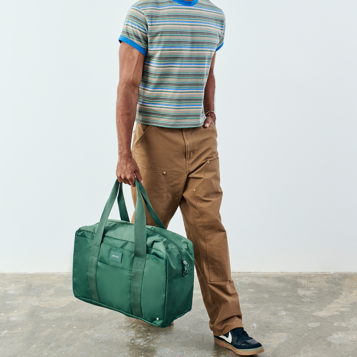 man holding state bags wellington weekender medium olive
