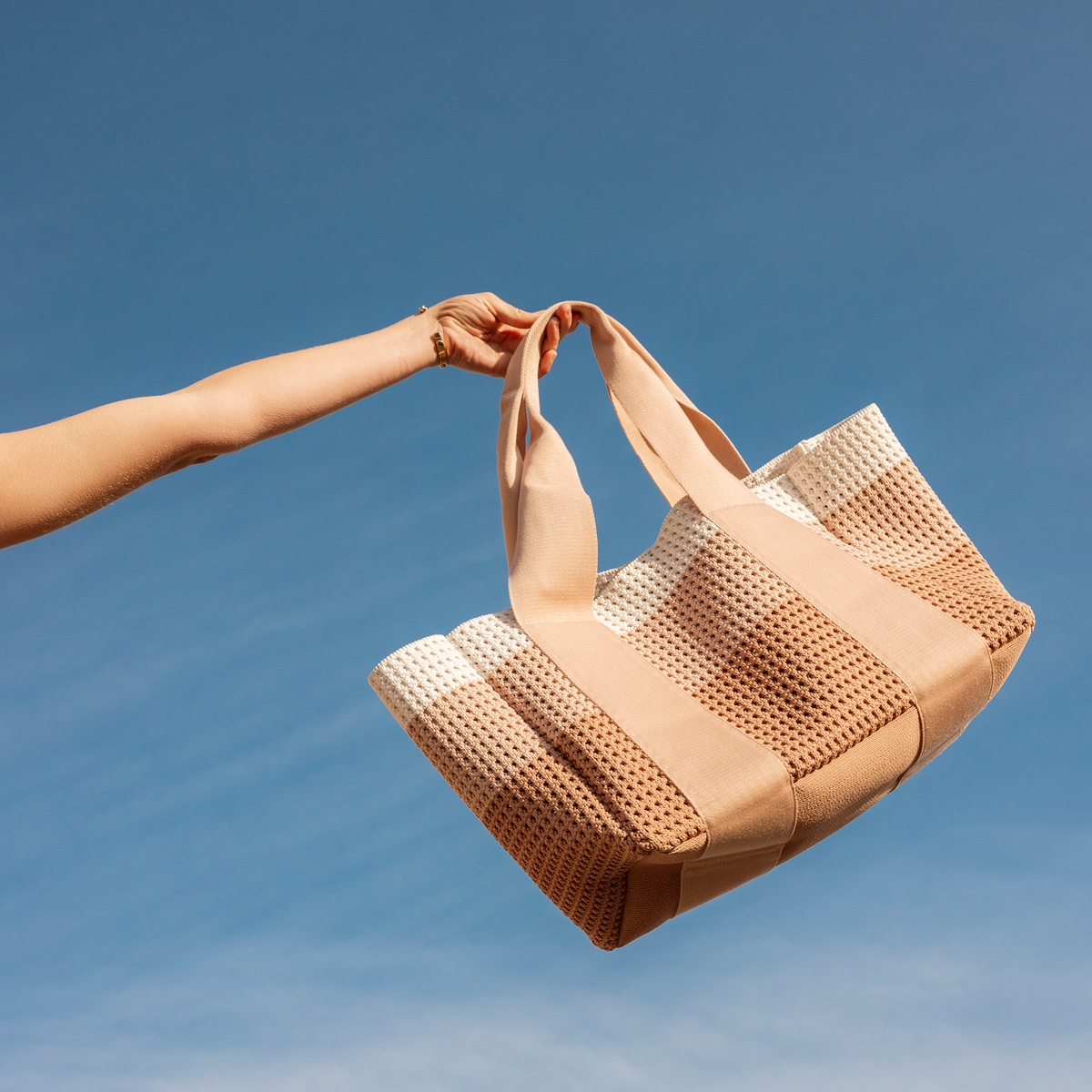 woamn holding STATE Bags Wellington Cabana Tote Neutral Stripe
