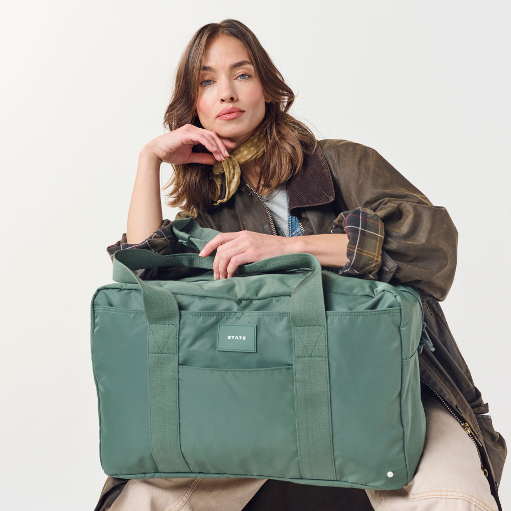 Woman holding STATE Bags Wellington Weekender Click to Zoom