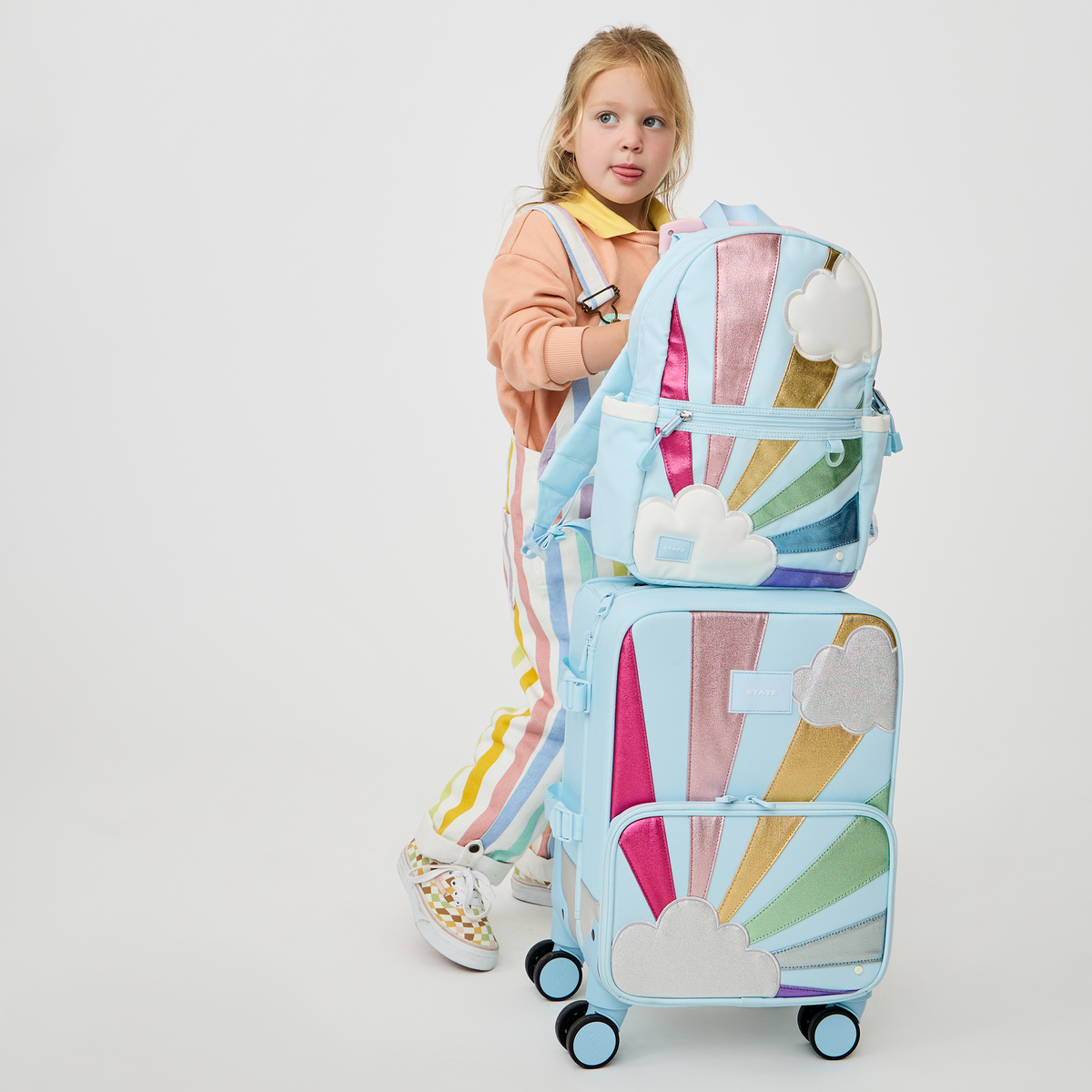 girl with STATE Bags Logan Carry-On Suitcase Rainbow Cloud 
