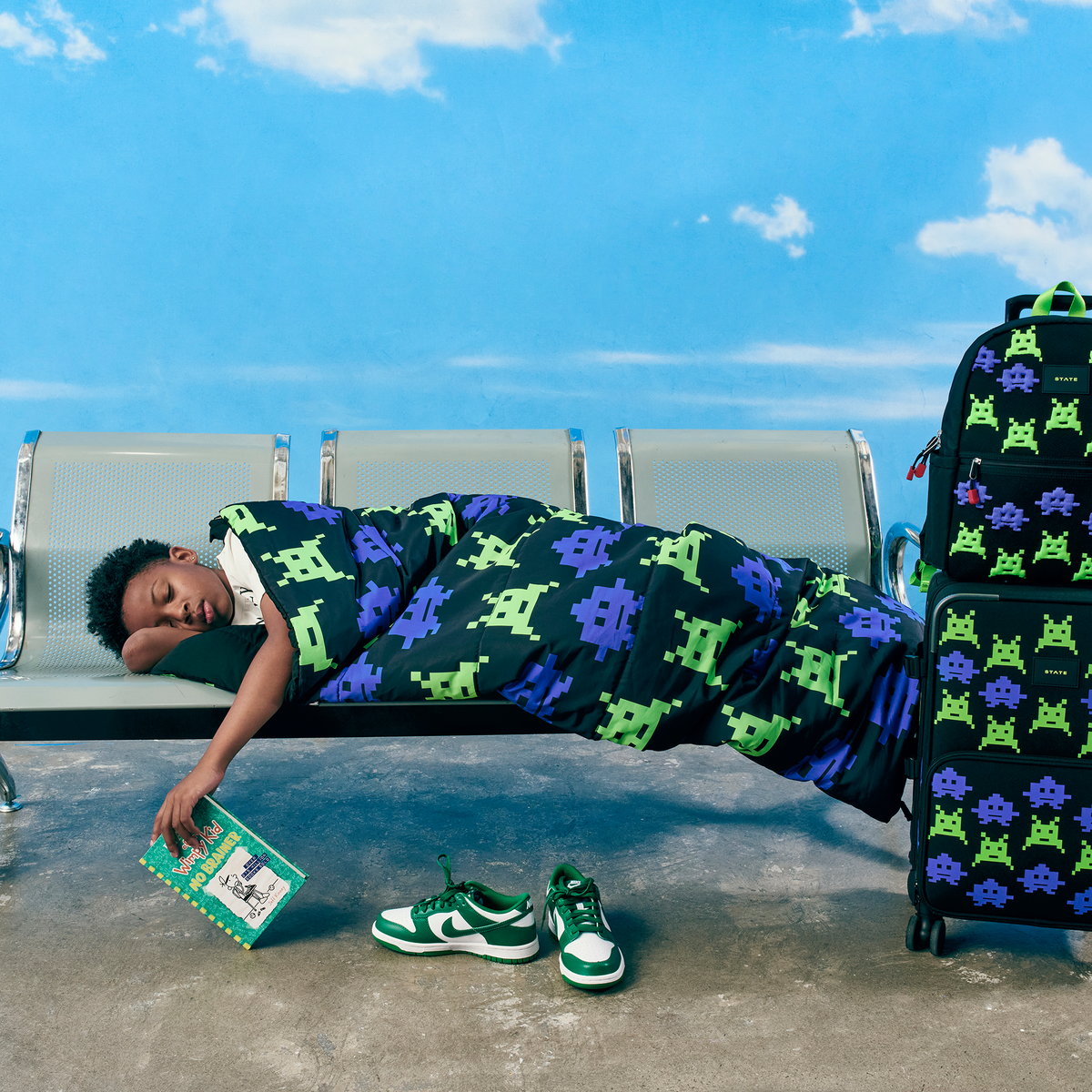 Boy sleeping at airport in state bags redwood sleeping bag arcade