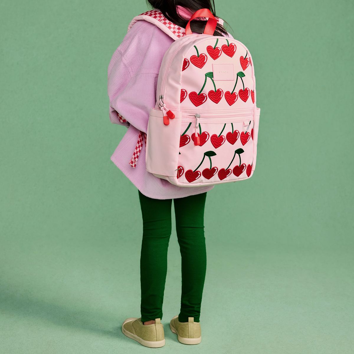 girl wearing STATE Bags Kane Mini Backpack Cherry