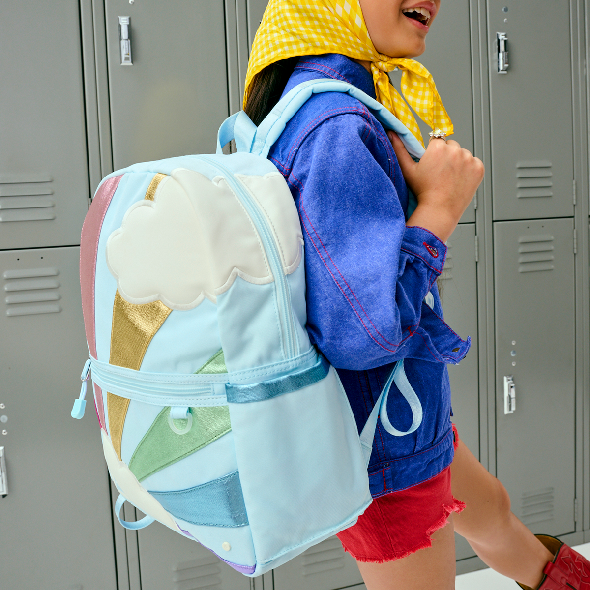 girl wearing STATE Bags Kane Backpack Rainbow Clouds