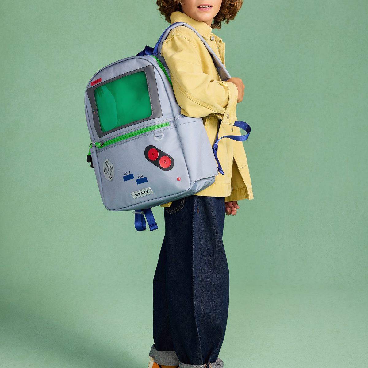 Boy wearing STATE Bags Kane Backpack videogame