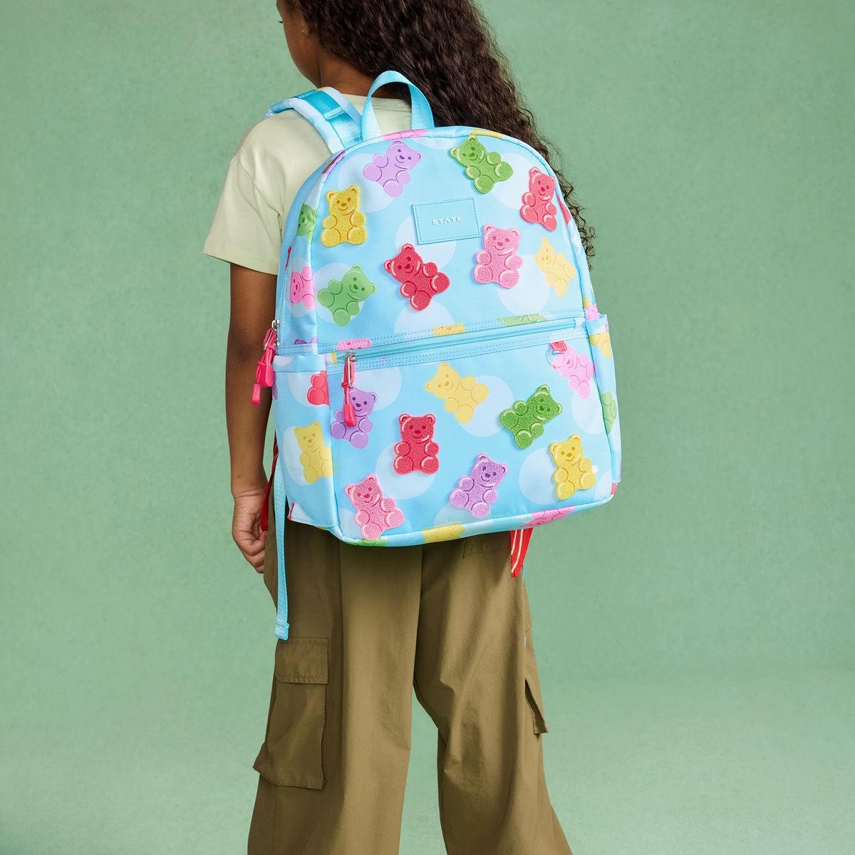 girl wearing STATE Bags Kane Backpack Gummy Bears