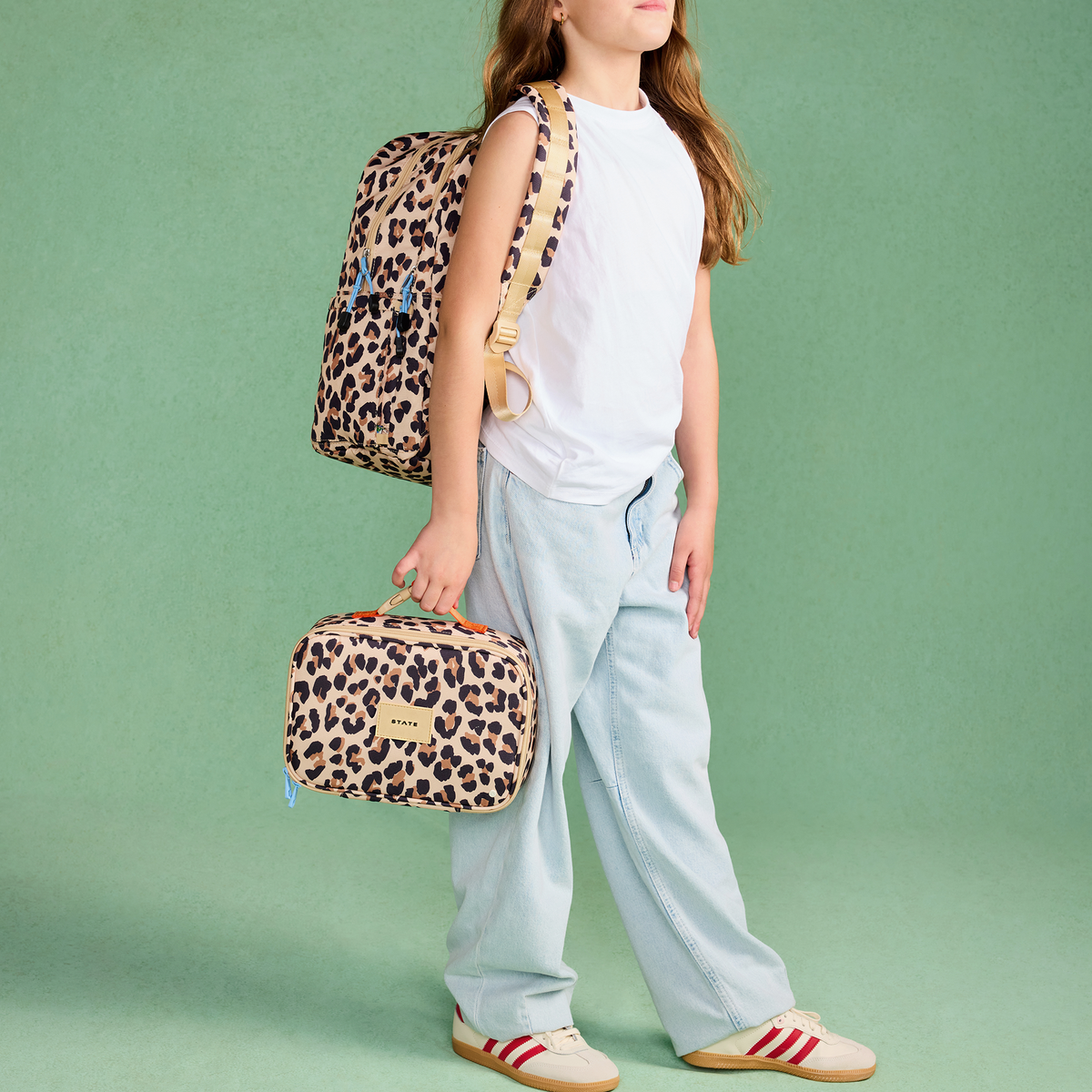 girl wearing STATE Bags Kane Double Pocket Backpack Leopard