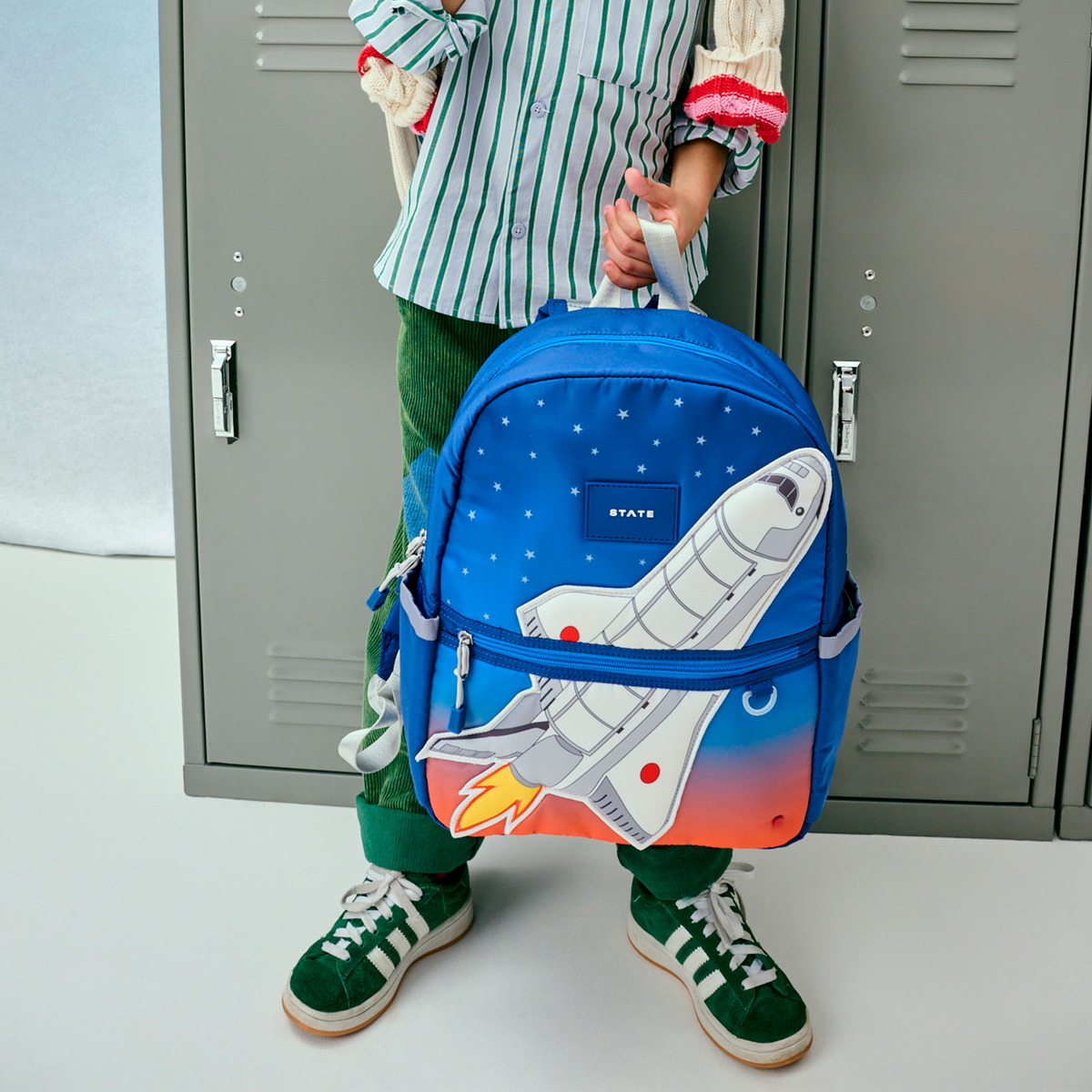 boy holding kane backpack spaceship