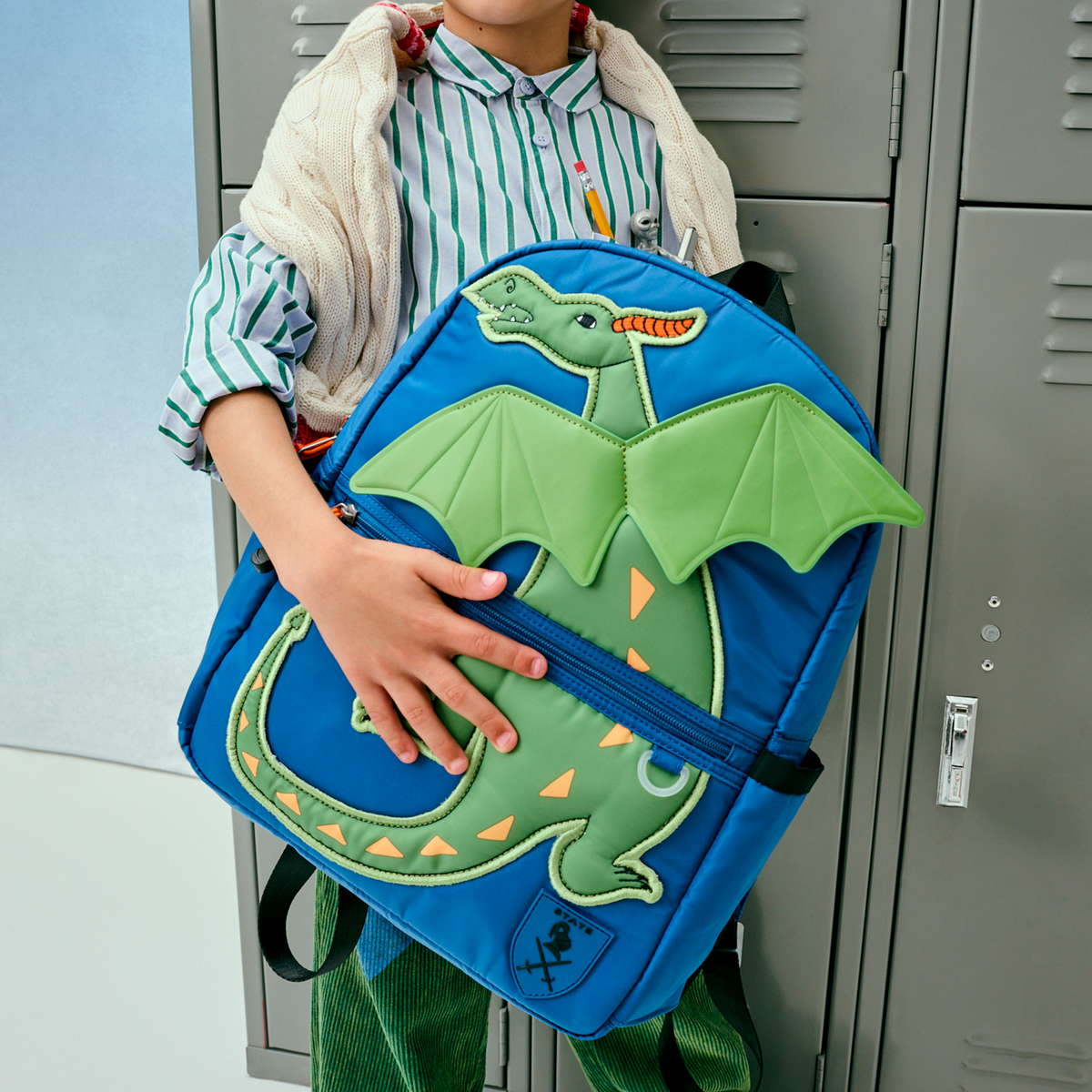 boy wearing kane backpack dragon 