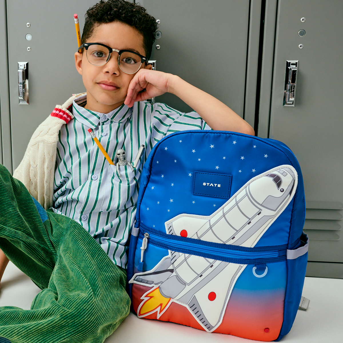 boy holding kane backpack spaceship