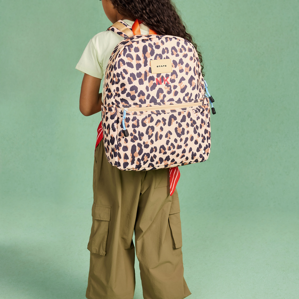 girl wearing STATE Bags Kane Backpack Leopard