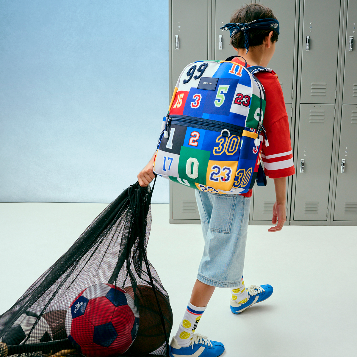 Boy wearing STATE Bags Kane Backpack Varsity Numbers