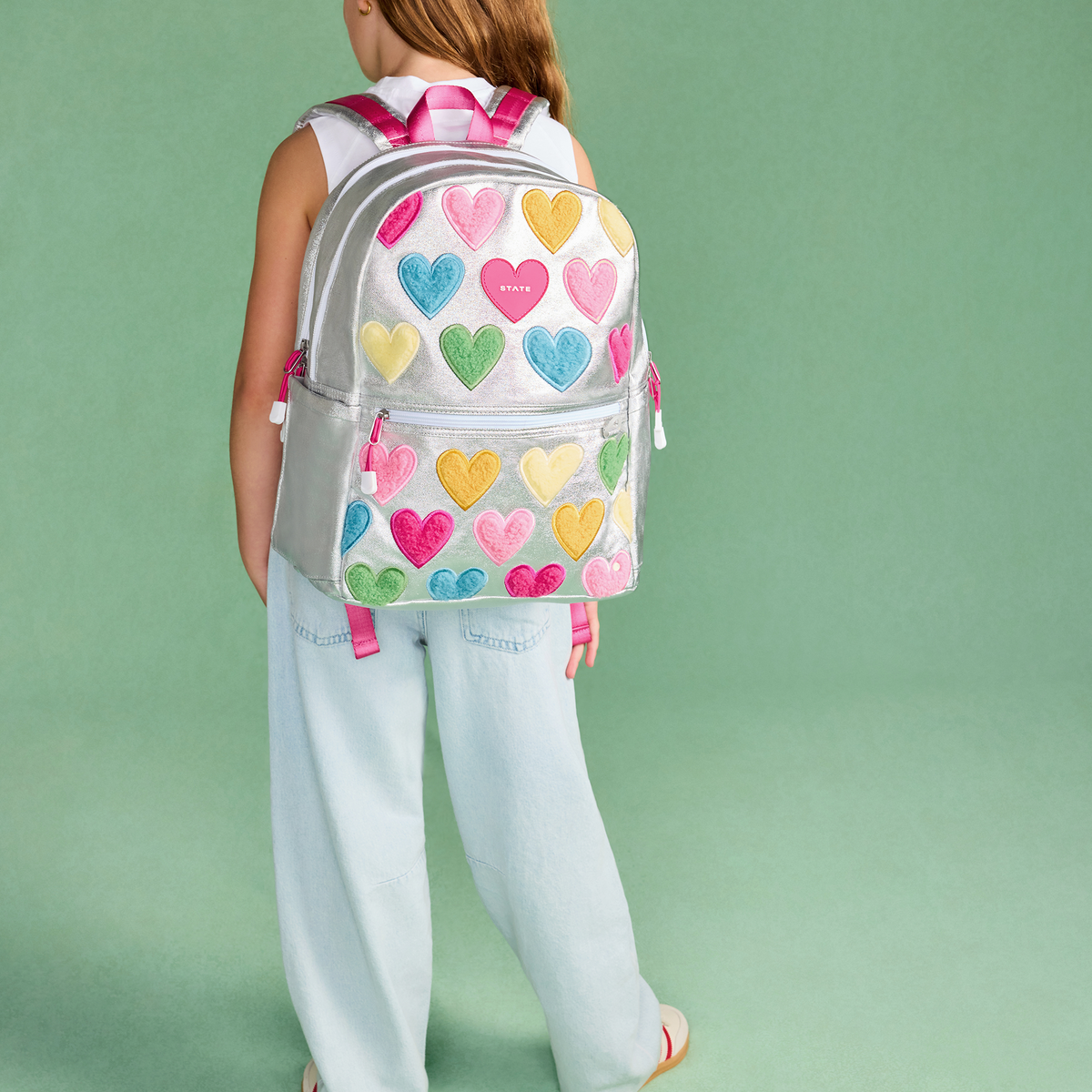 girl wearing STATE Bags Kane Double Pocket Backpack Happy Fuzzy Hearts