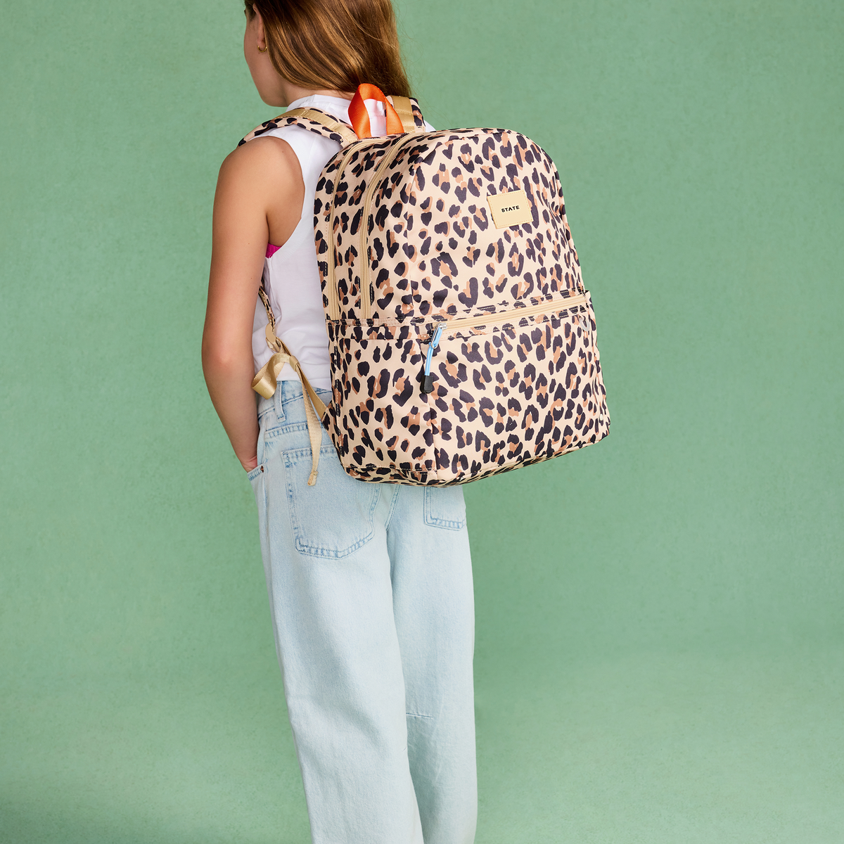 girl wearing STATE Bags Kane DP Backpack Leopard