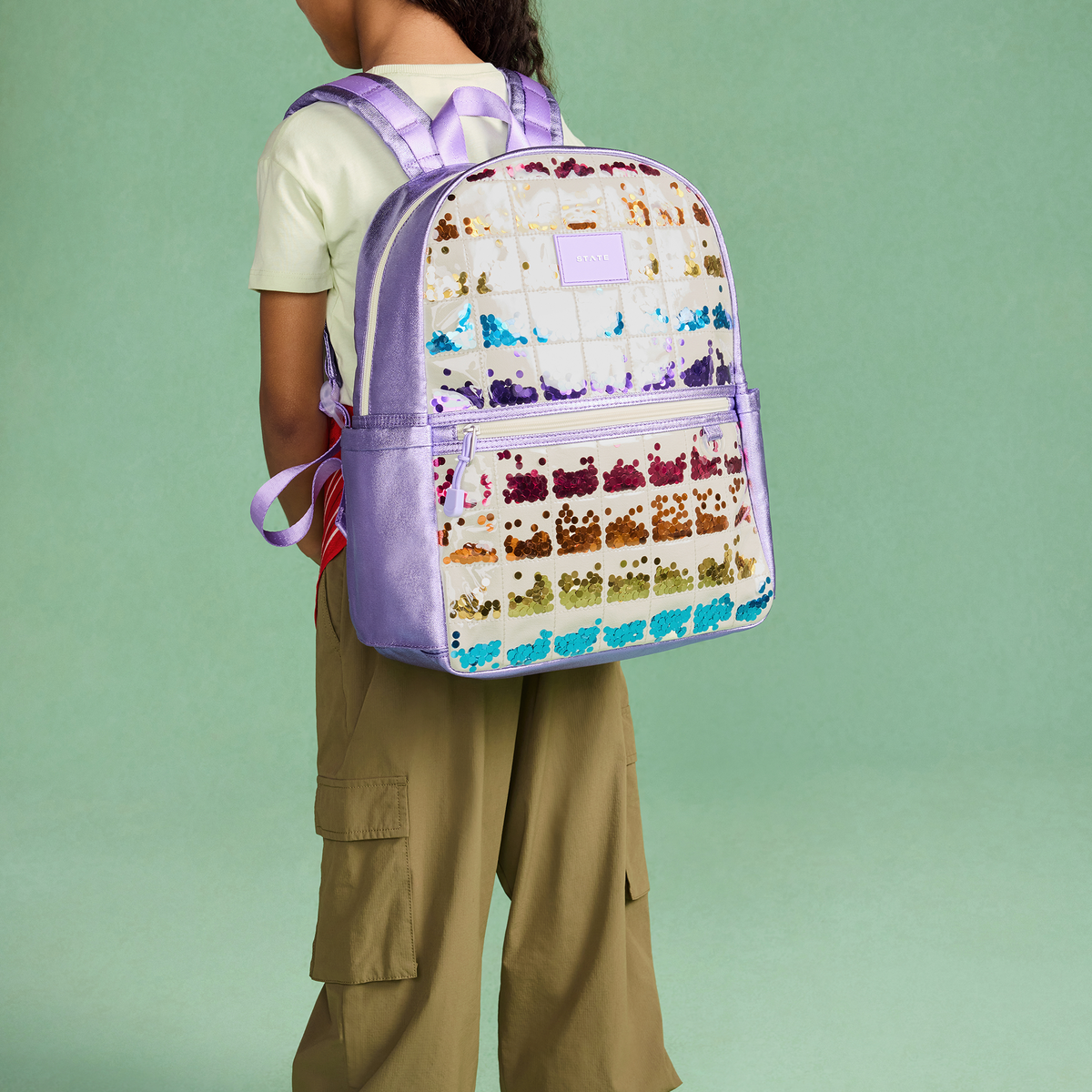 girl wearing STATE bags lilac quilted sequin kane backpack