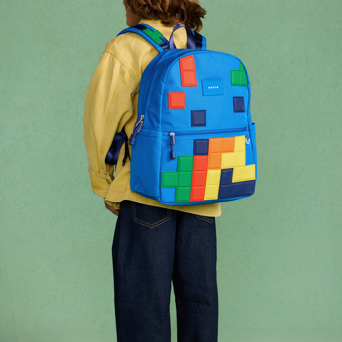  boy wearing STATE Kane Backpack digital puzzle
