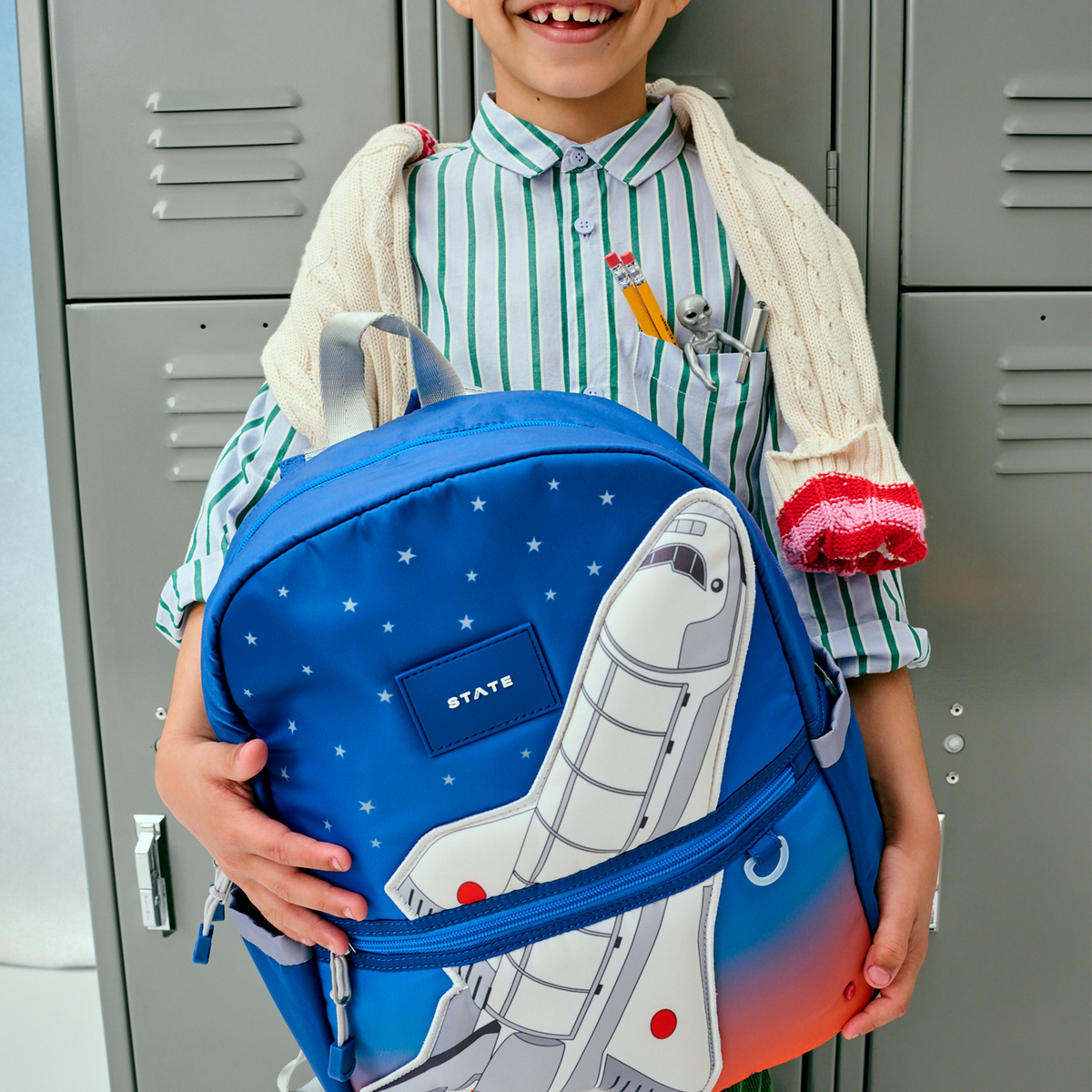 boy holding kane backpack spaceship