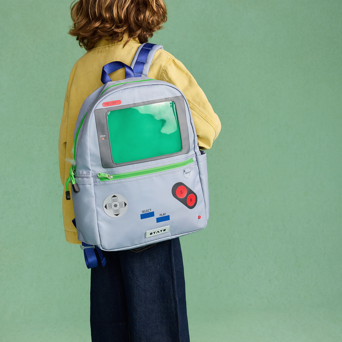 Boy wearing STATE Bags Kane Backpack videogame