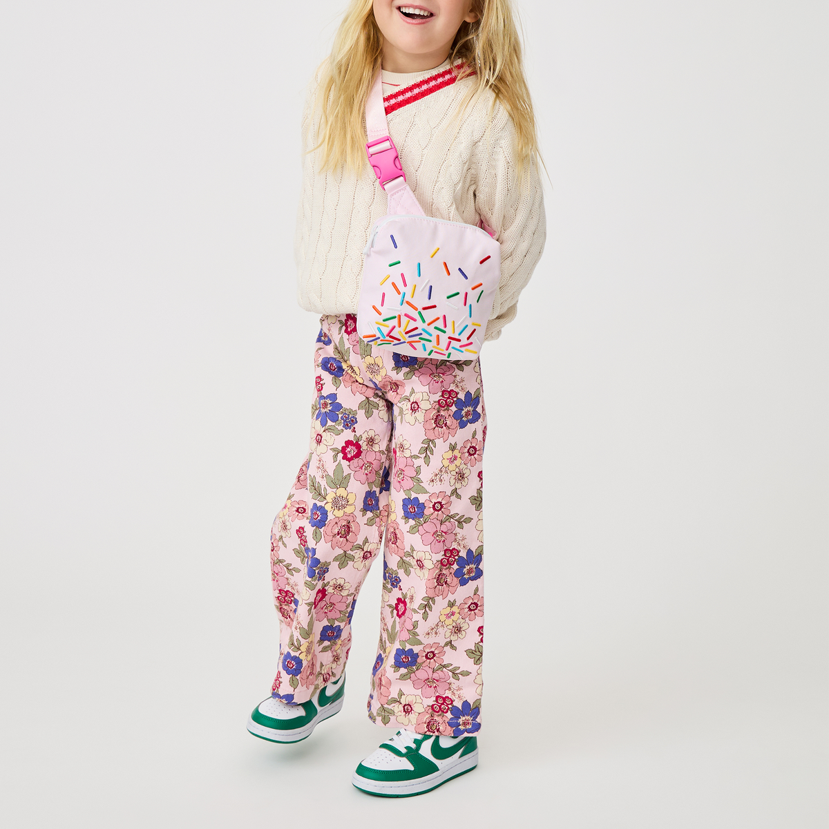 girl holding sunny kids fanny pack sprinkles