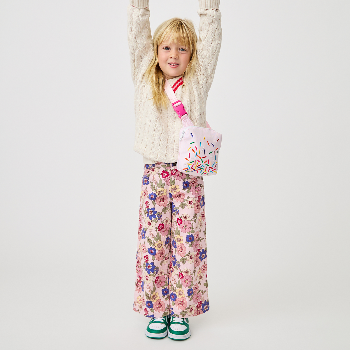 girl holding sunny kids fanny pack sprinkles