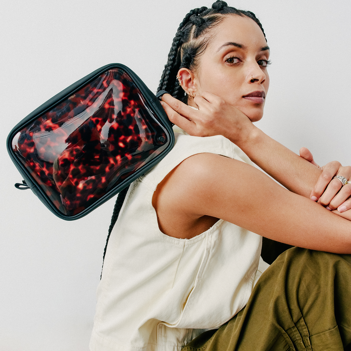 woman holding STATE Bags Travel Pouch Set of Three Tortoise 