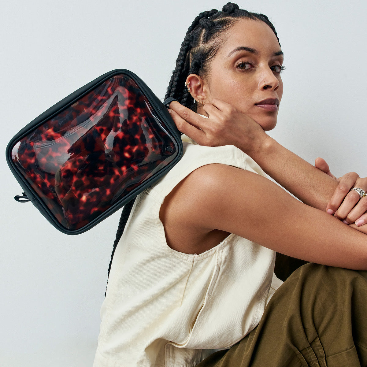 woman holding STATE Bags Travel Pouch Set of Three Tortoise 
